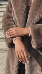 Rose quartz beaded bracelet worn on wrist, soft pink natural stone jewellery